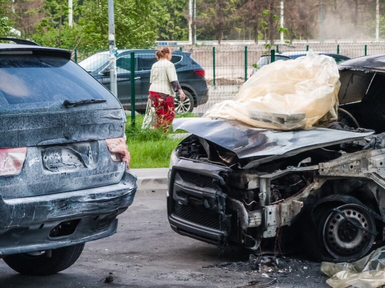 Car accidents involving multiple vehicles in a residential parking area causing extensive property damage.