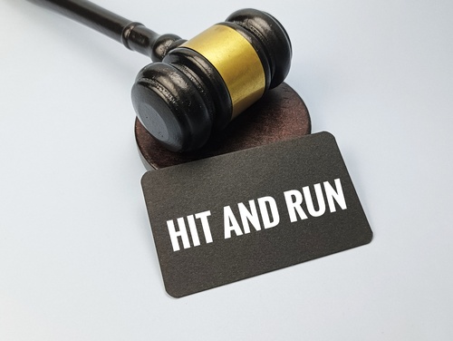 A gavel and a card that reads "hit-and-run" representing a judge reviewing a hit-and-run accident case..jpg