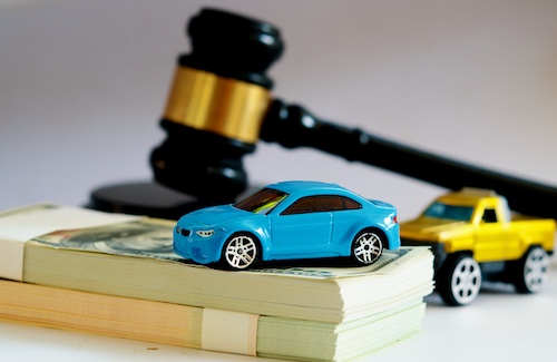 Car Accident Compensation Concept With Money, Toy Cars, and Gavel