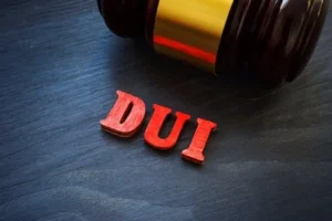 Close-up of DUI lettering and a gavel, illustrating criminal defense work for DUI and DWI charges.