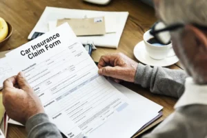 Accident victim reviewing insurance claim documents after being hit by out-of-state driver in Tennessee, showing the complexity of non-resident motorist claims