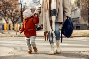 Nashville pedestrian accident lawyer, mom and child at crosswalk in danger of becoming victims of reckless drivers.