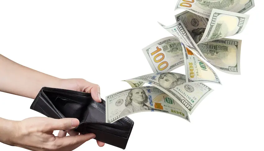 Two hands hold open a thin black leather bifold wallet against a pure white background as multiple crisp American hundred-dollar bills appear to fly out of it in a dynamic sweeping arc toward the upper right corner of the frame- the bills twisting and fanning outward with Benjamin Franklin's portrait- the bold numeral 100, green treasury seals- and blue security strips clearly visible on the faces of the departing currency — a striking visual metaphor for the financial drain an injury victim experiences when they are unable to work and suffer lost wages while recovering from an accident in Tennessee.